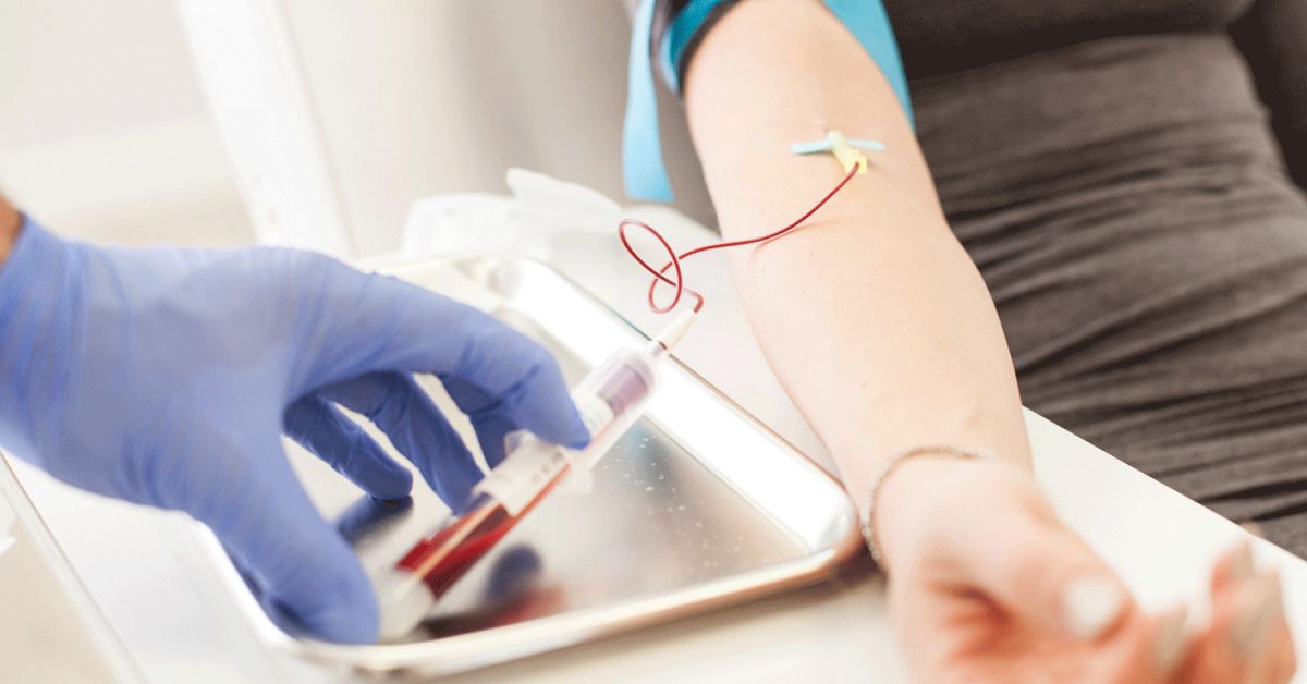 Healthcare professional drawing blood for PRP therapy from a patient's arm, showcasing the integration of chiropractic care and regenerative medicine at Infinite Wellness.